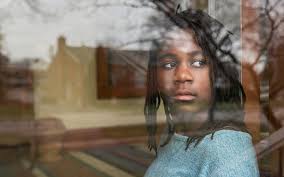 teen girl looking out window